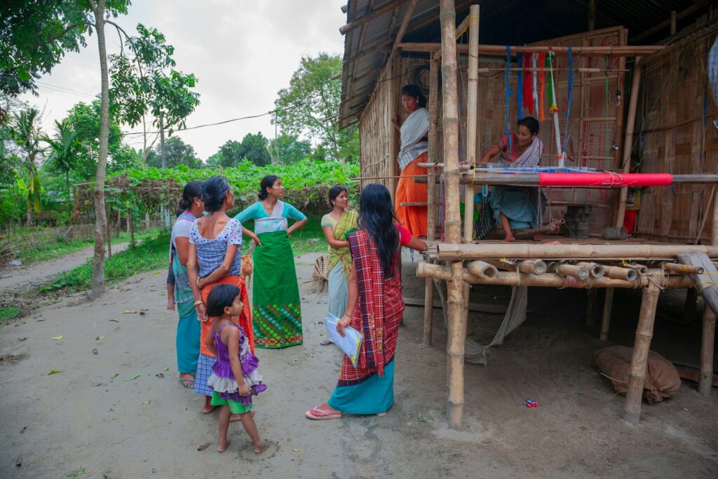 Women gathered around a traditional loom